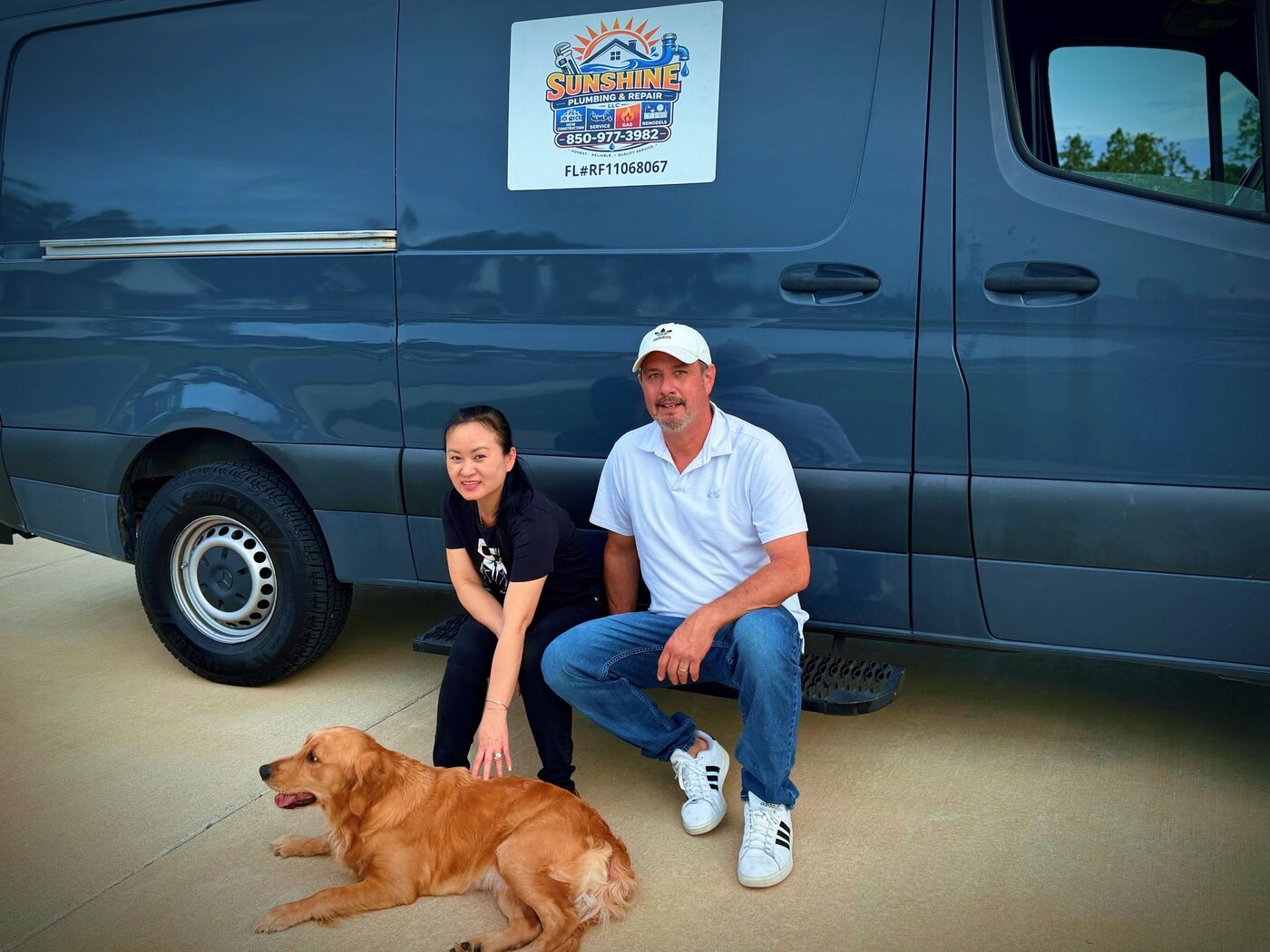 Rich and his wife with their dog beside the Sunshine Plumbing & Repair van